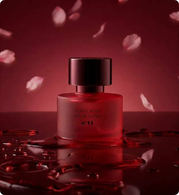 Luxury perfume bottle on pink reflective surface